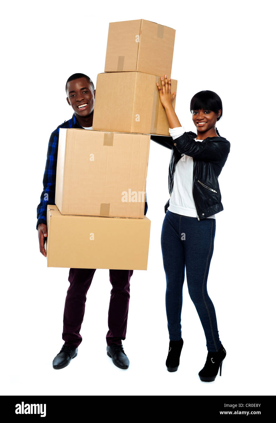 Attractive young couple standing with cardboard boxes. Smiling at camera Stock Photo
