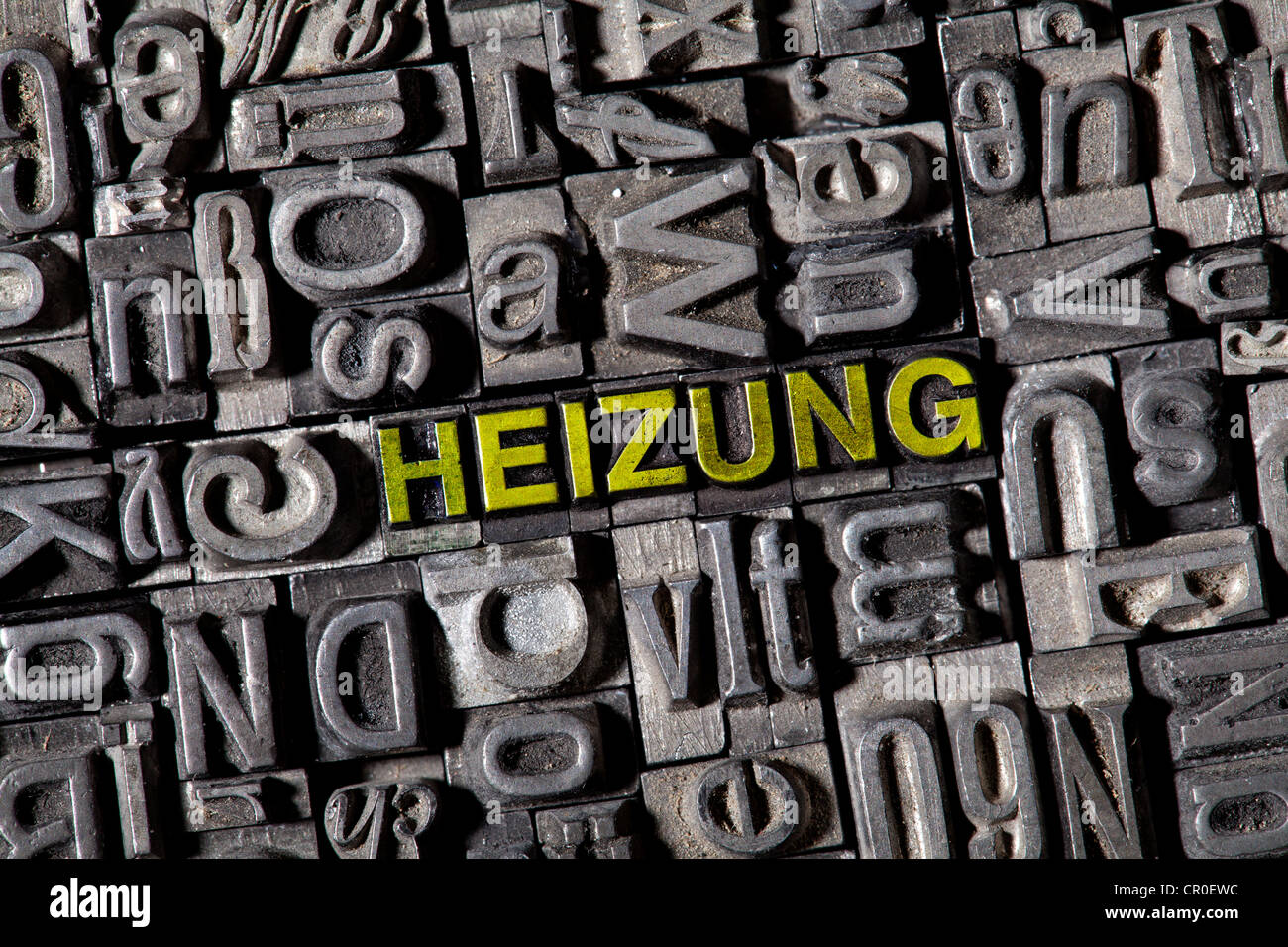 Old lead letters forming the word Heizung, German for heating Stock Photo
