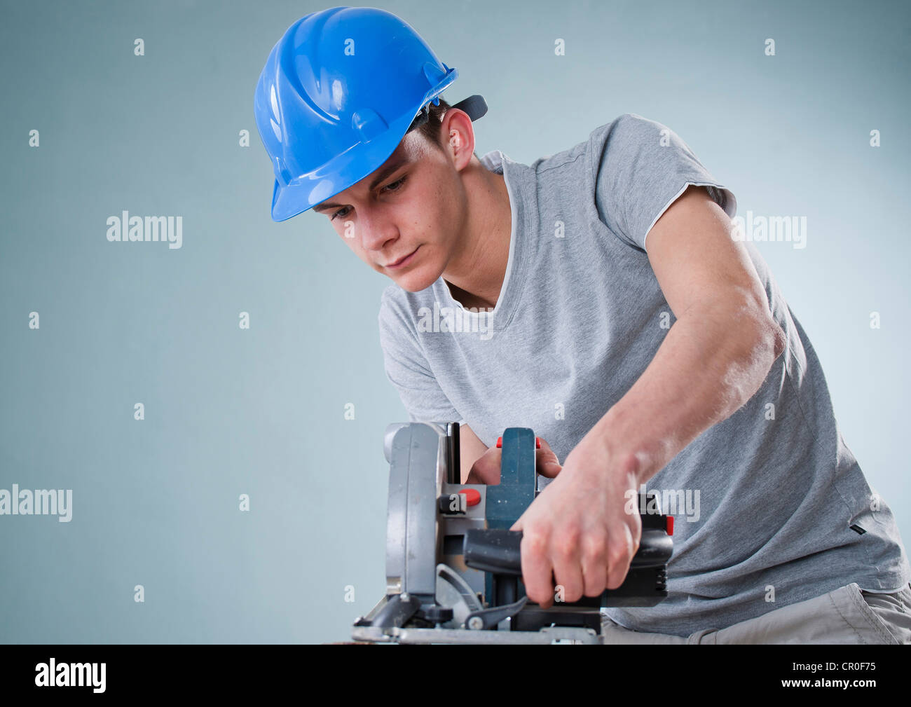 Young tradesman using a jigsaw Stock Photo