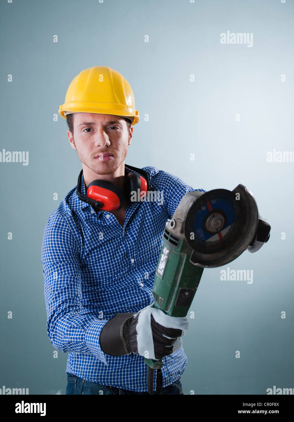 Young tradesman holding an angle grinder Stock Photo