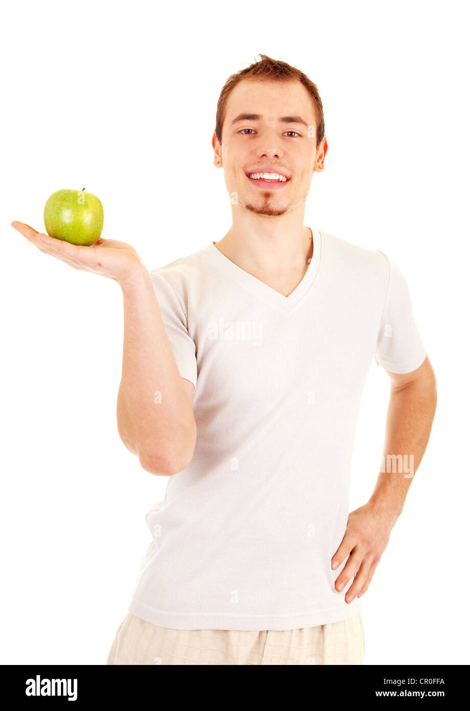 Young handsome man is holding a green apple on his palm. On white background. Stock Photo