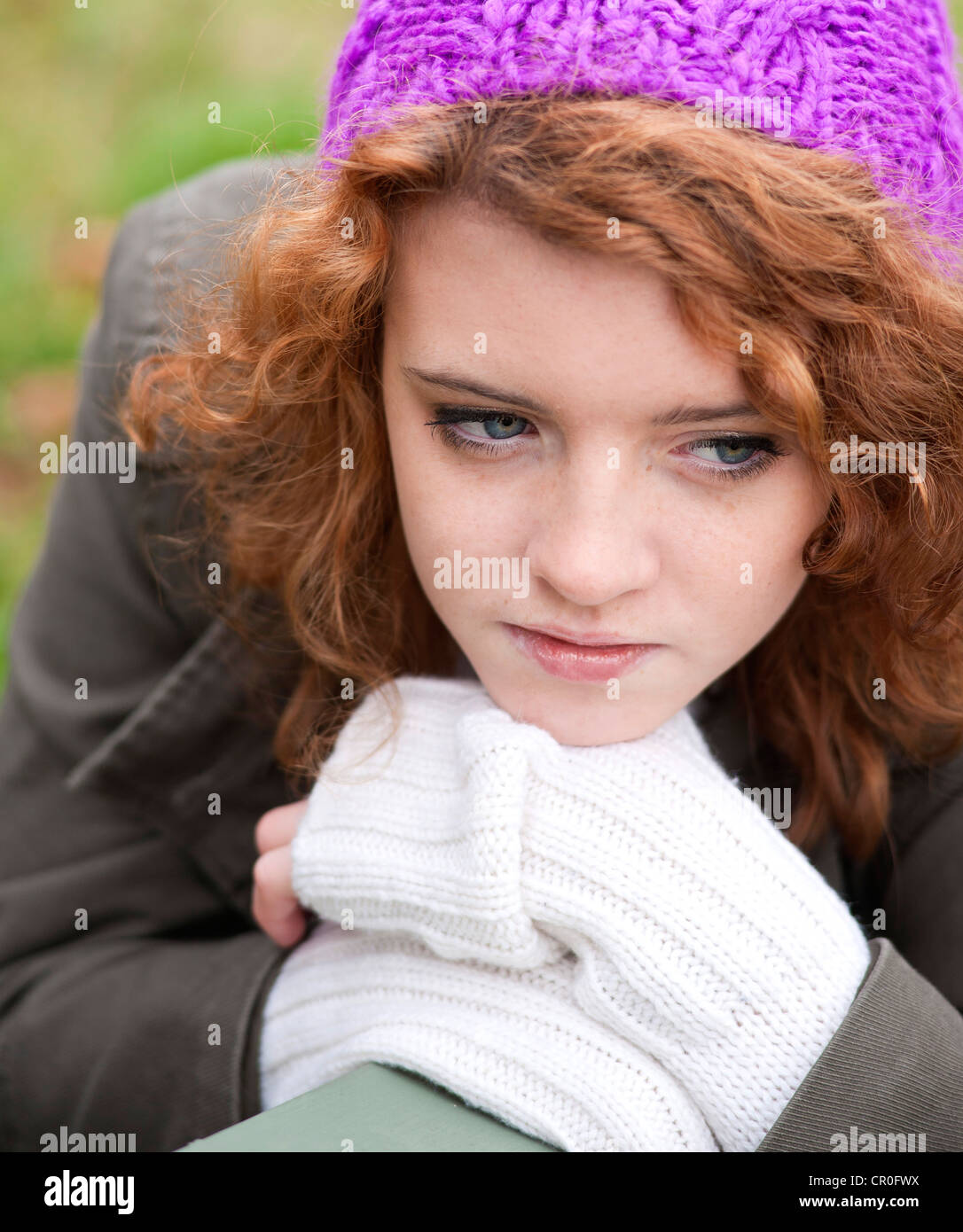 Girl wearing a woollen cap with a dreamy expression, portrait Stock Photo