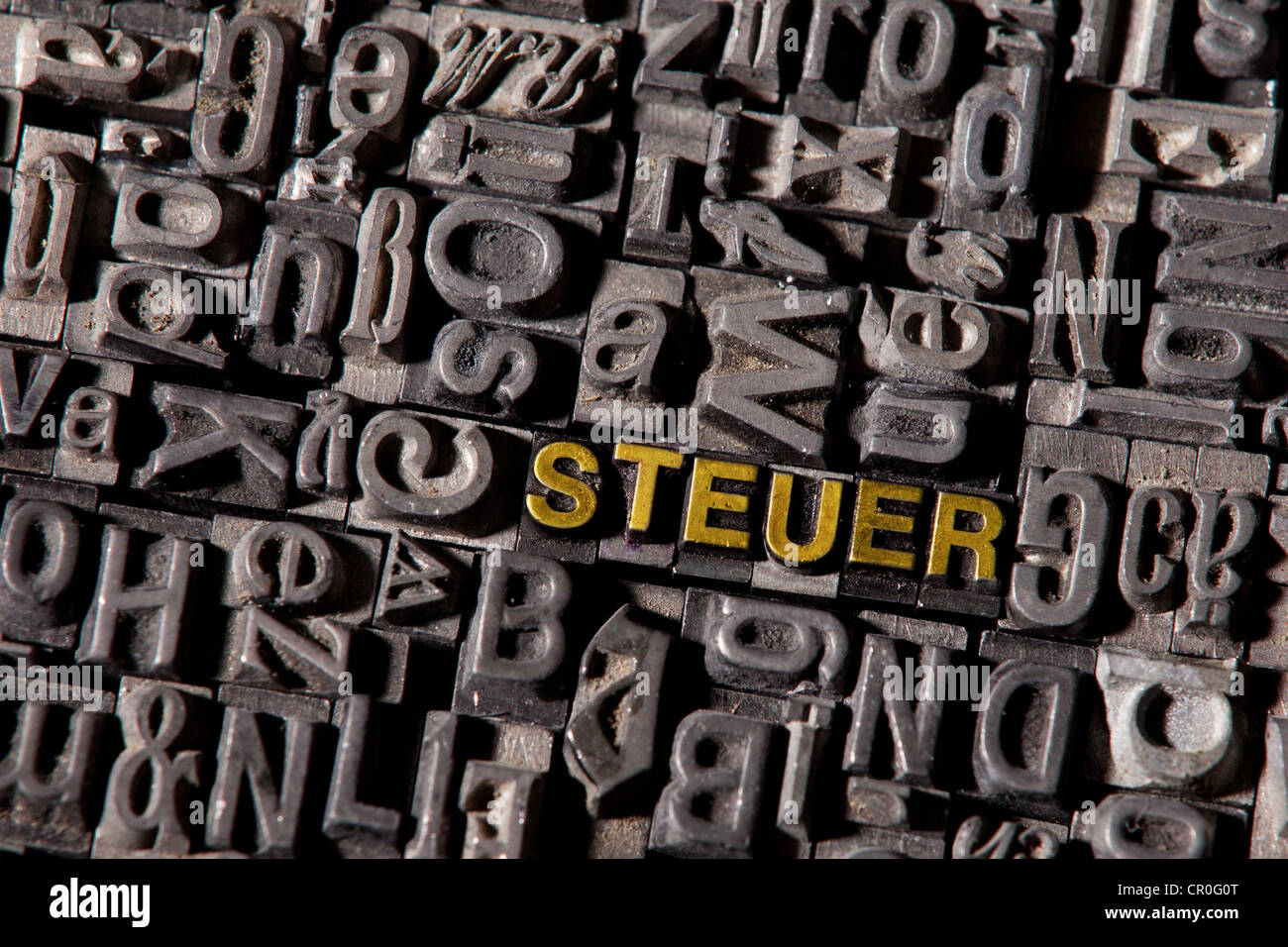 The word 'Steuer', German for 'tax', made of old lead type Stock Photo