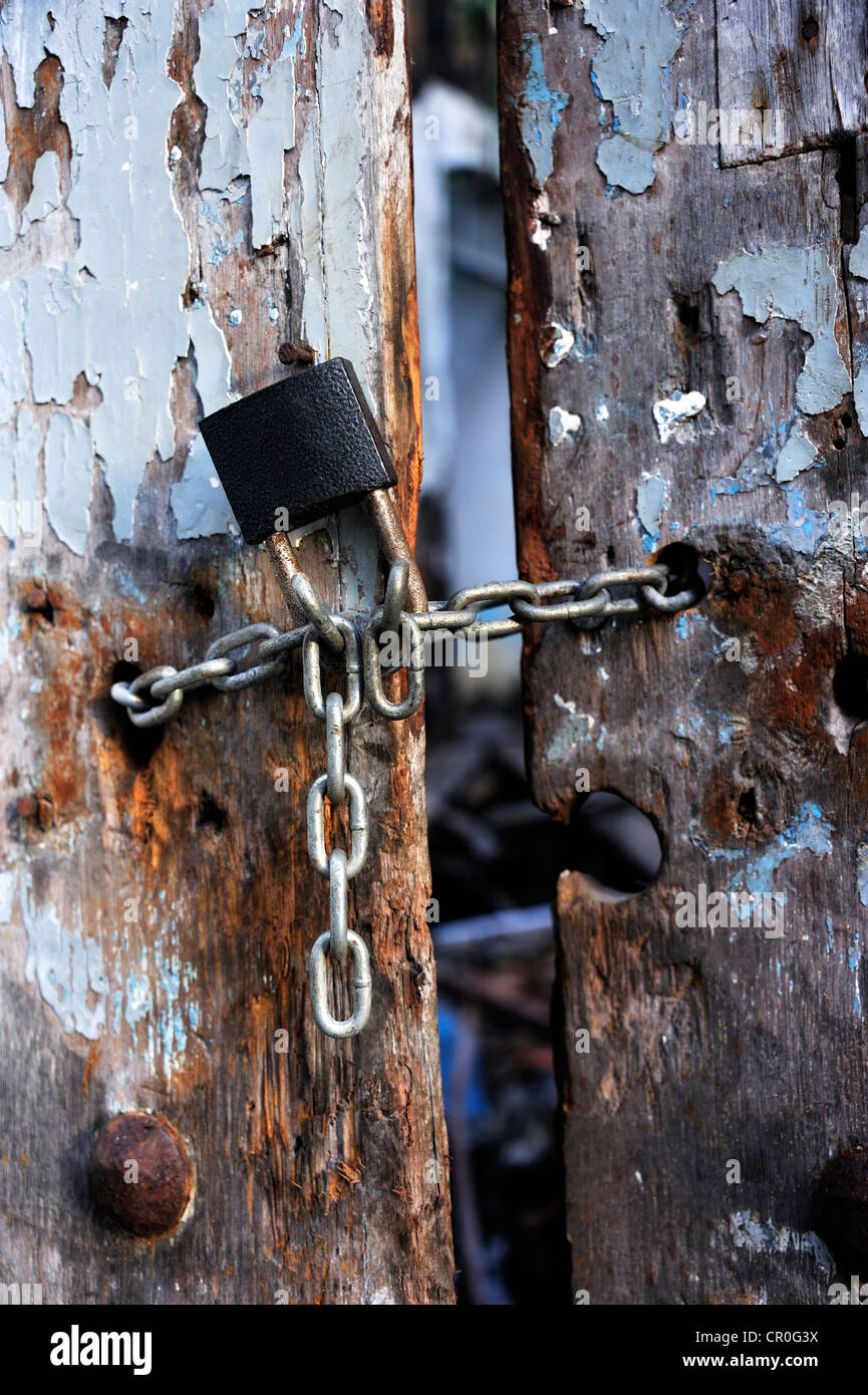Padlock and chain on an old wooden gate, Sao Luis, Maranhao, Brazil, South America Stock Photo