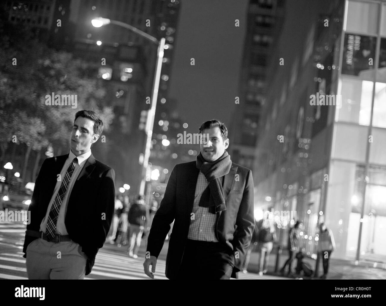2 men take a stroll at night in New York City Stock Photo Alamy