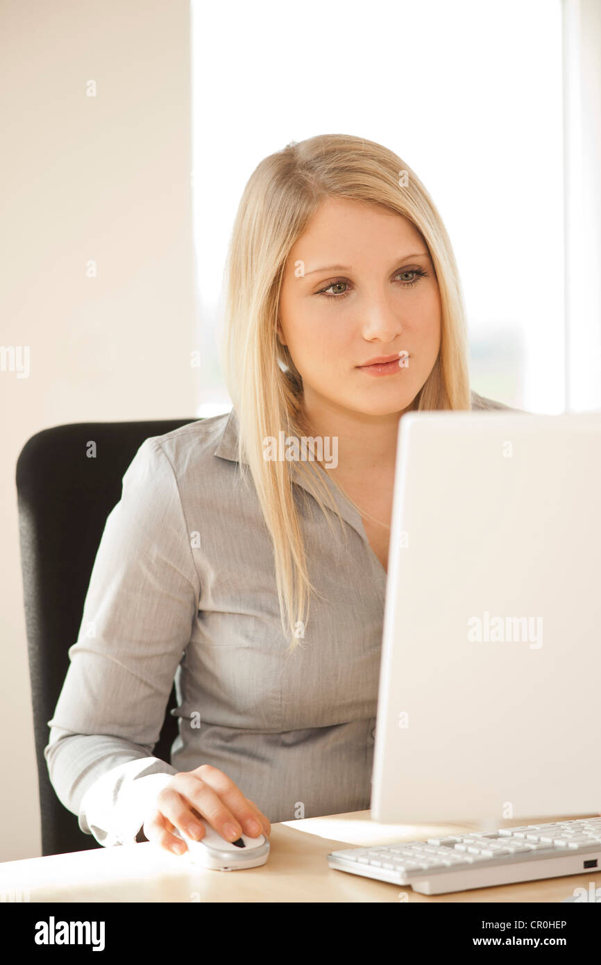 Young woman working on computer Stock Photo - Alamy