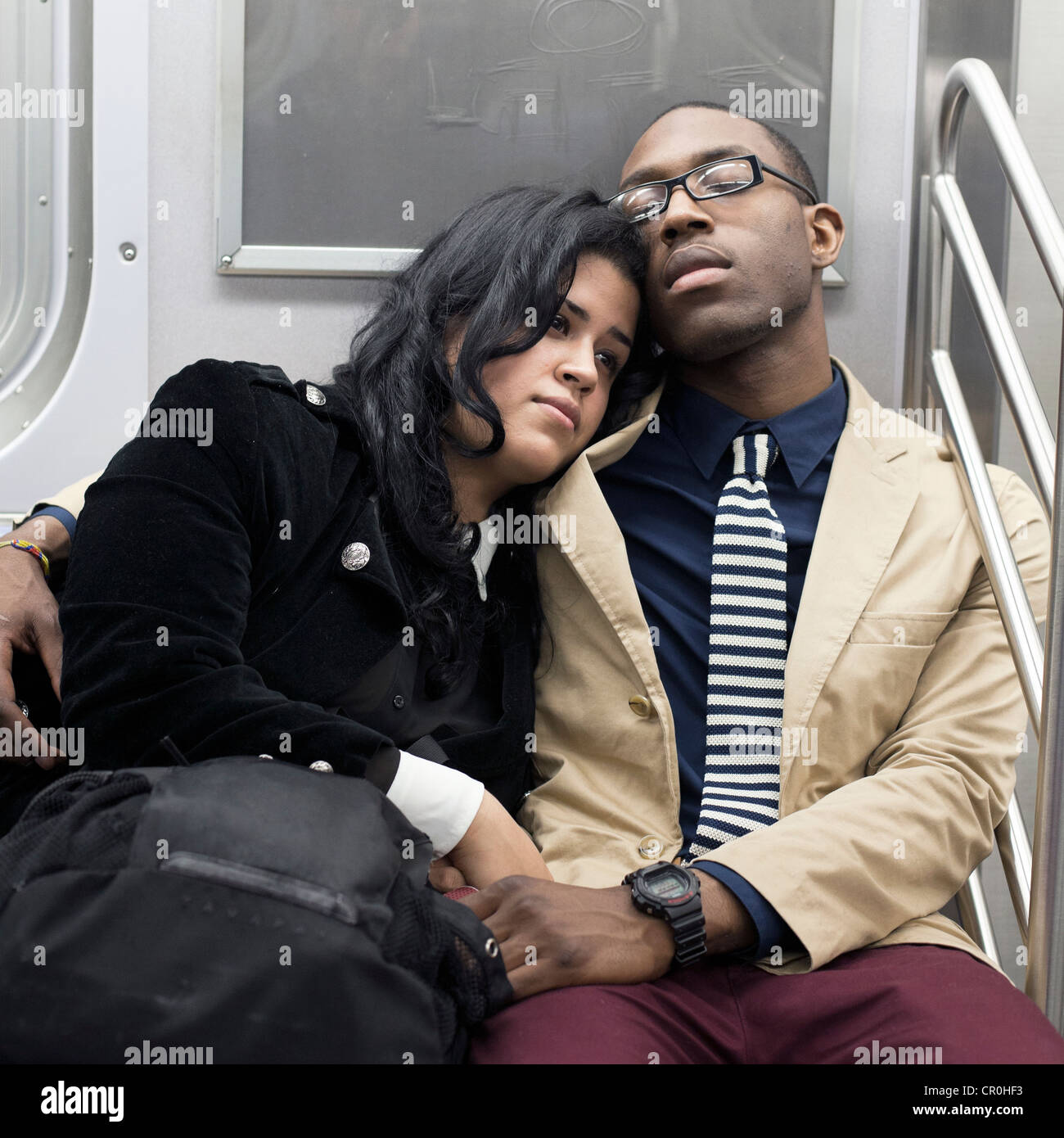 A young couple relaxes together on the subway in New York City. Stock Photo