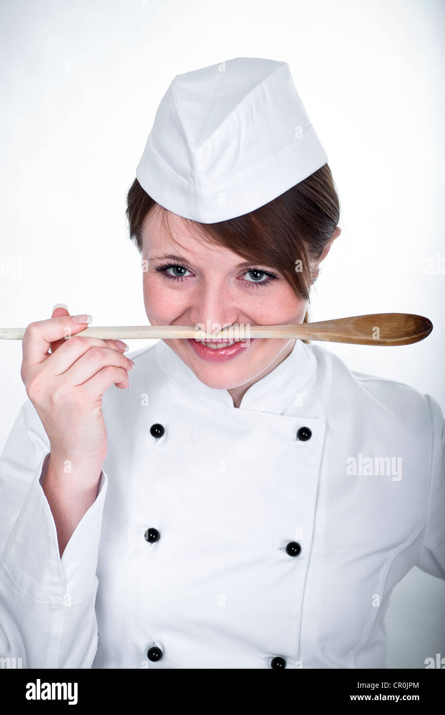Young female cook with a spoon Stock Photo