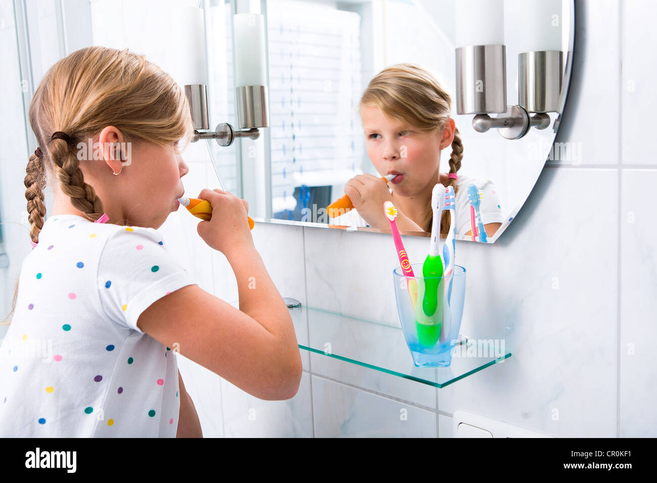 Little girl brushing her teeth in the bathroom Stock Photo Alamy