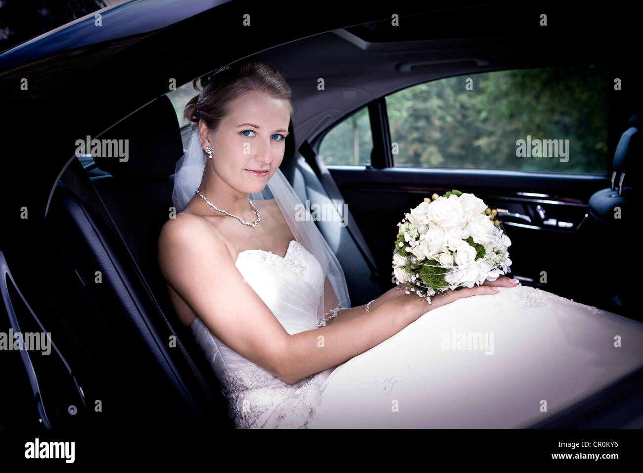 Young bride in a car Stock Photo