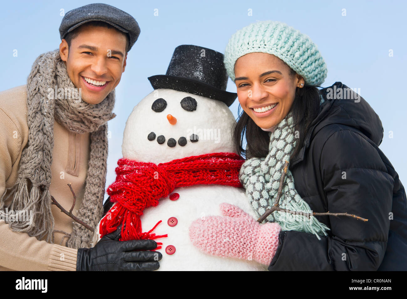 USA, New Jersey, Jersey City, Portrait of couple with snowman Stock ...