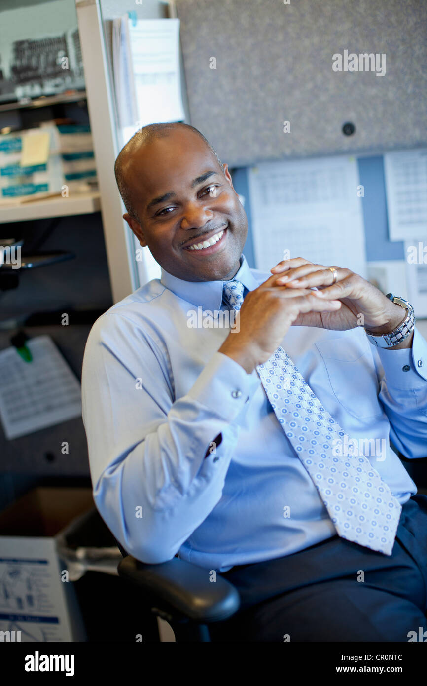 African American businessman sitting in office cubicle Stock Photo - Alamy