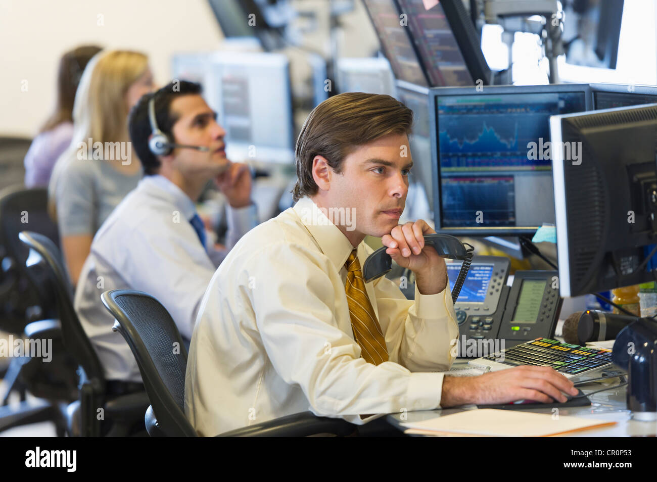 USA, New York, New York City, Traders at trading desk Stock Photo
