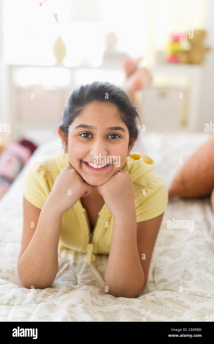 USA, New Jersey, Jersey City, Portrait of girl (1213) lying on bed