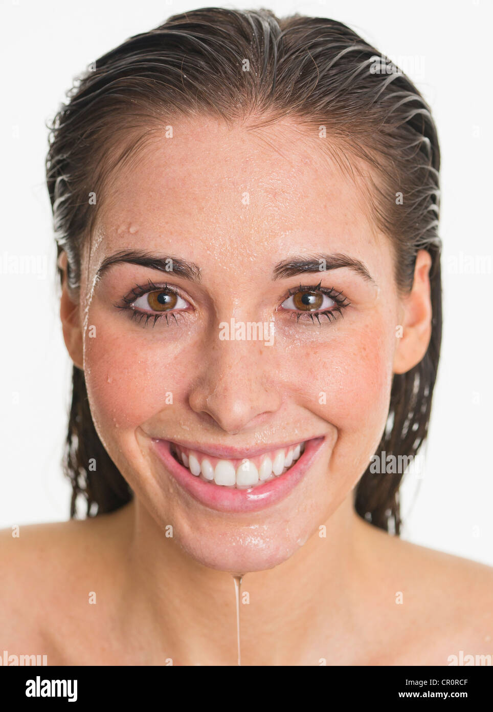 Studio portrait of woman with wet face Stock Photo