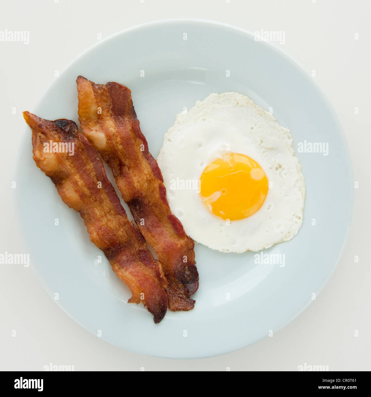 Close up of fried egg with bacon, studio shot Stock Photo