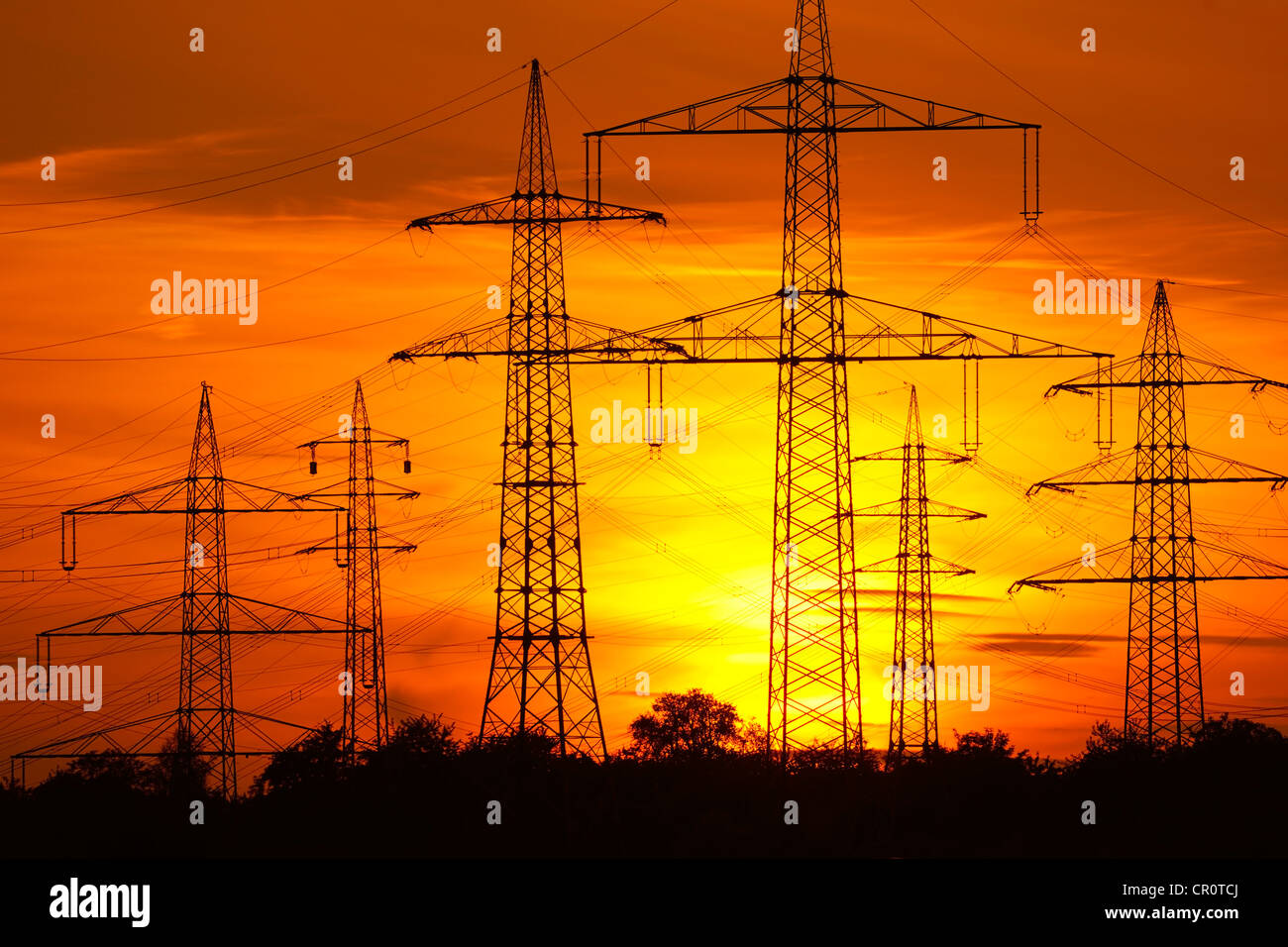 Transmission lines, overhead line towers, with setting sun, Beinstein in Stuttgart, Baden-Wuerttemberg, Germany, Europe Stock Photo