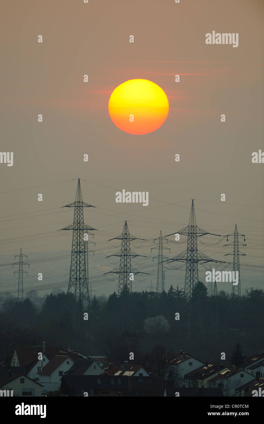 Electric power transmission lines, electricity pylons, with the setting sun, Korb near Stuttgart, Baden-Wuerttemberg Stock Photo