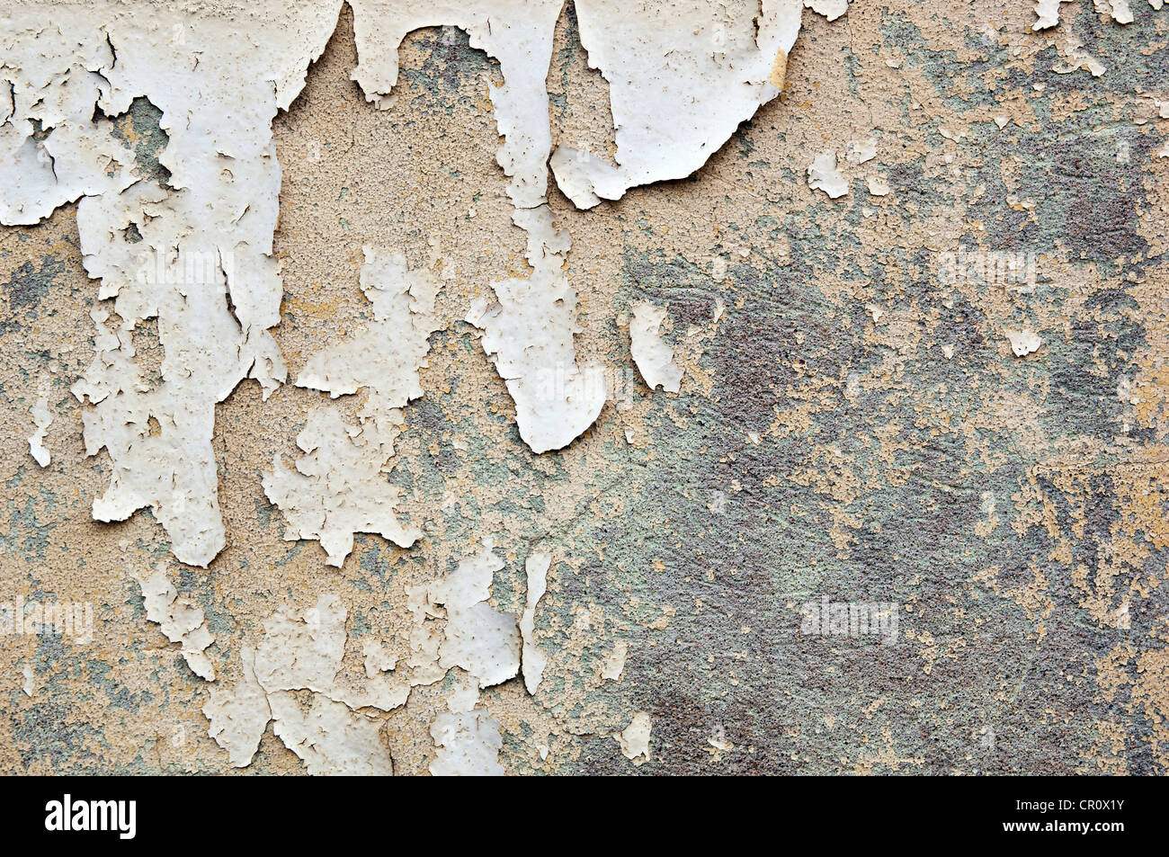 Paint peeling off a concrete wall forms grunge texture background Stock Photo