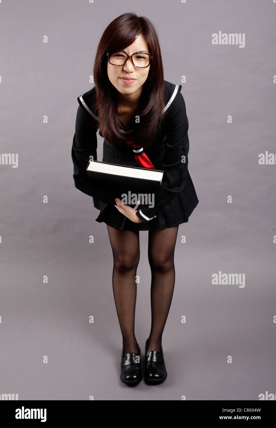 School girl lifts a heavy book Stock Photo - Alamy