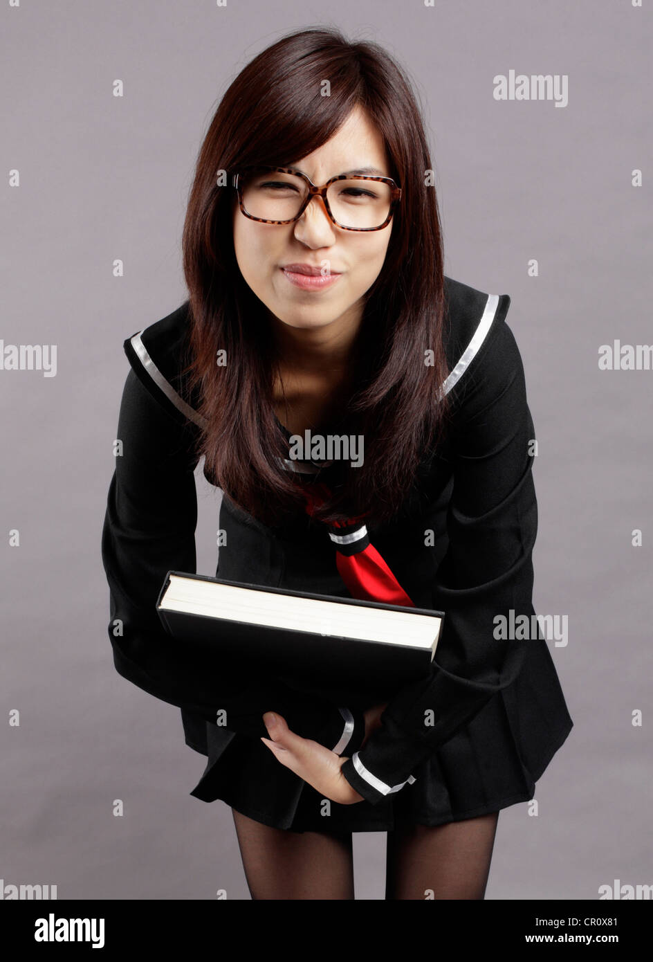 School girl lifts a heavy book Stock Photo - Alamy