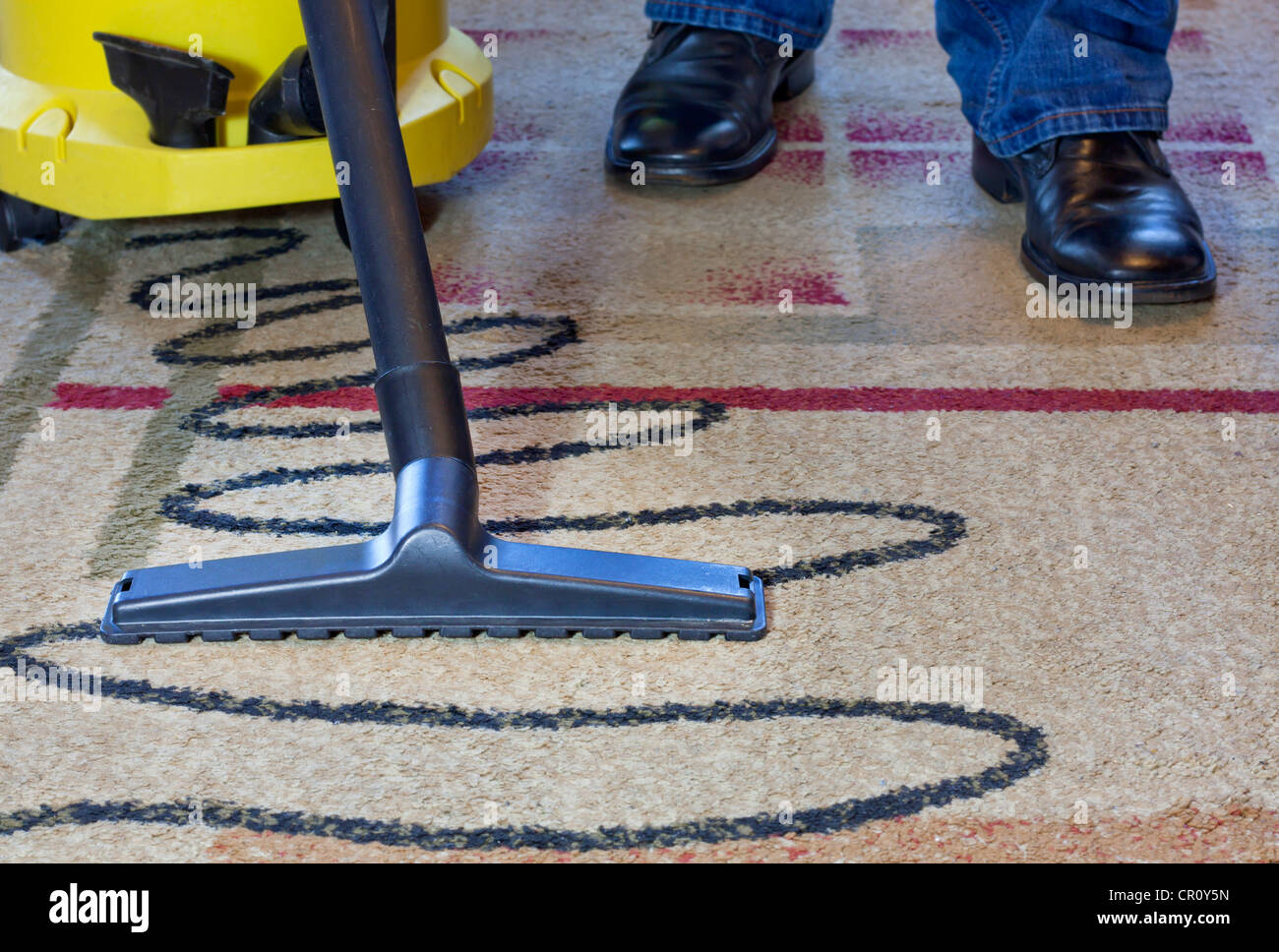 Man cleaning carpet at home vacuuming Stock Photo Alamy