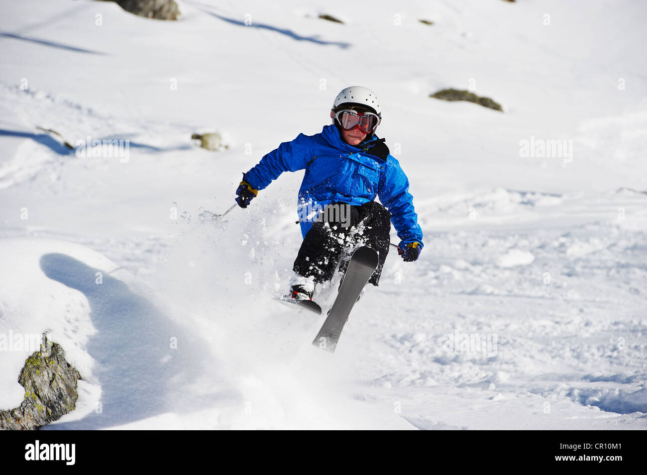 Boy skiing on snowy mountainside Stock Photo