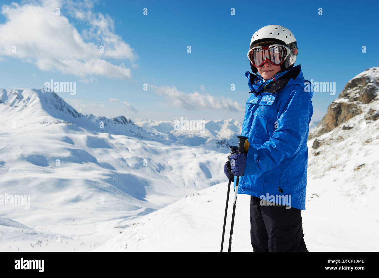 Boy in skis on snowy mountaintop Stock Photo