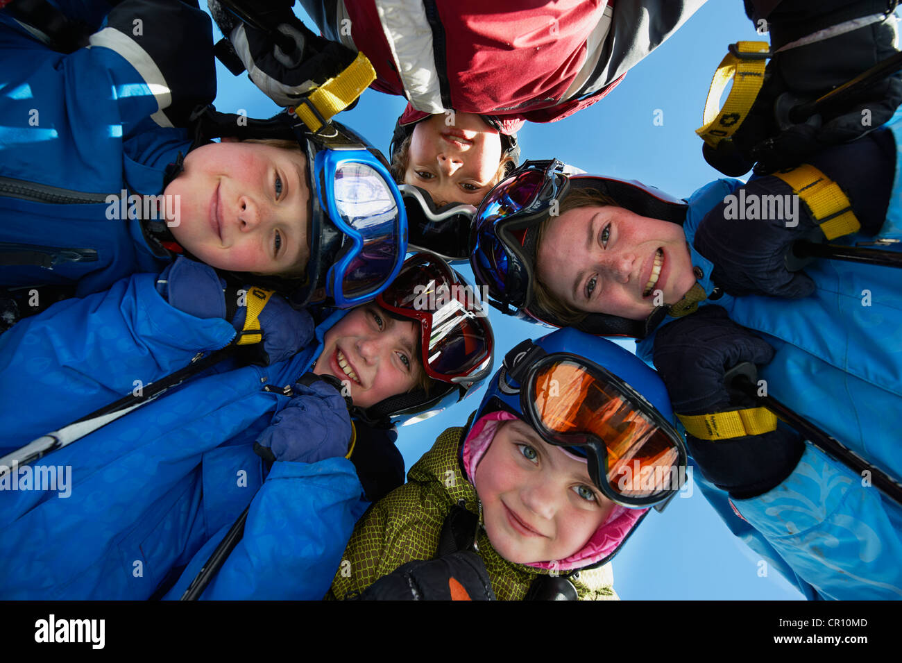 Children in ski gear standing together Stock Photo