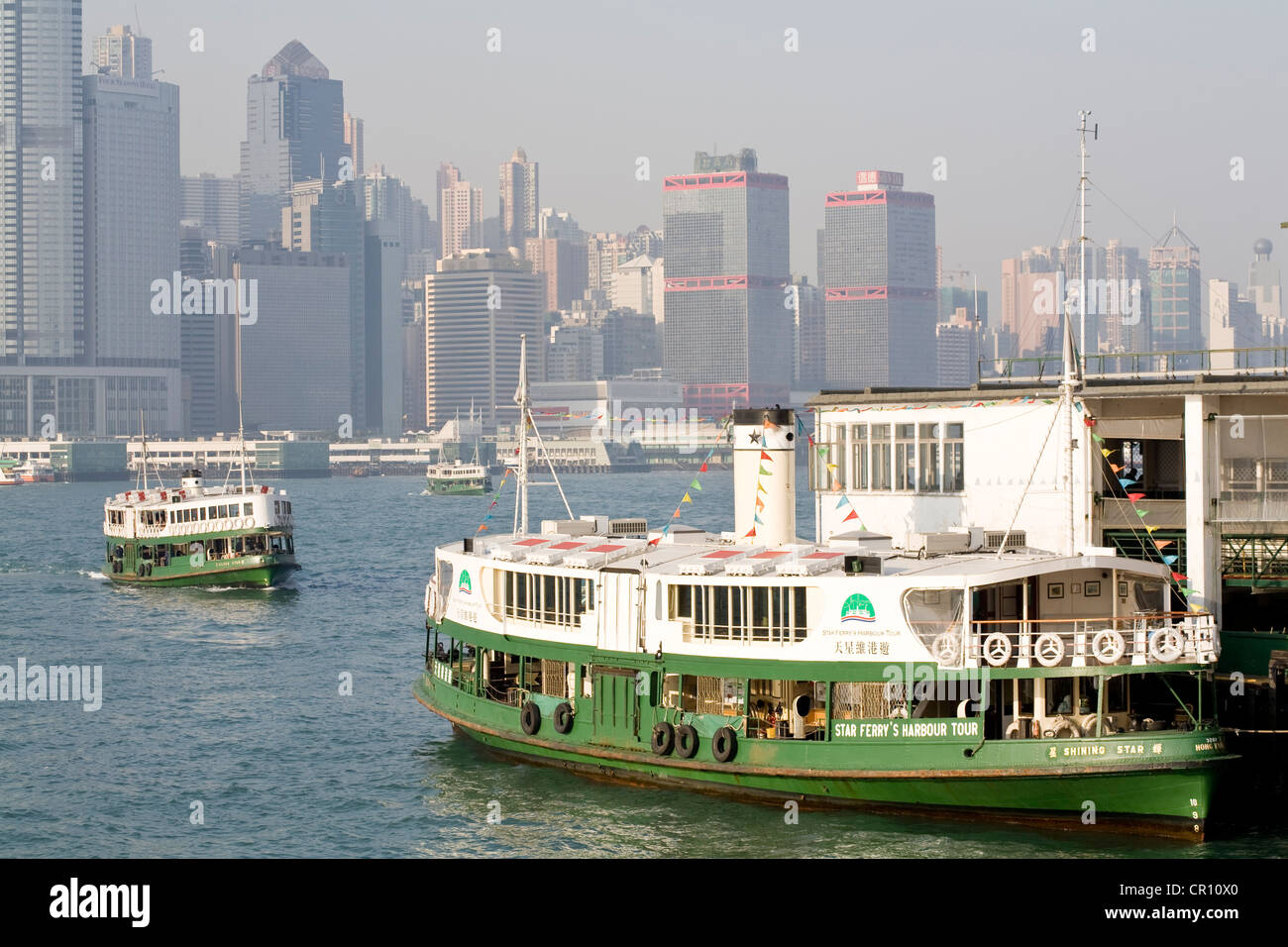 China, Hong Kong, Star Ferry Pier, ferries with Central District in the background Stock Photo
