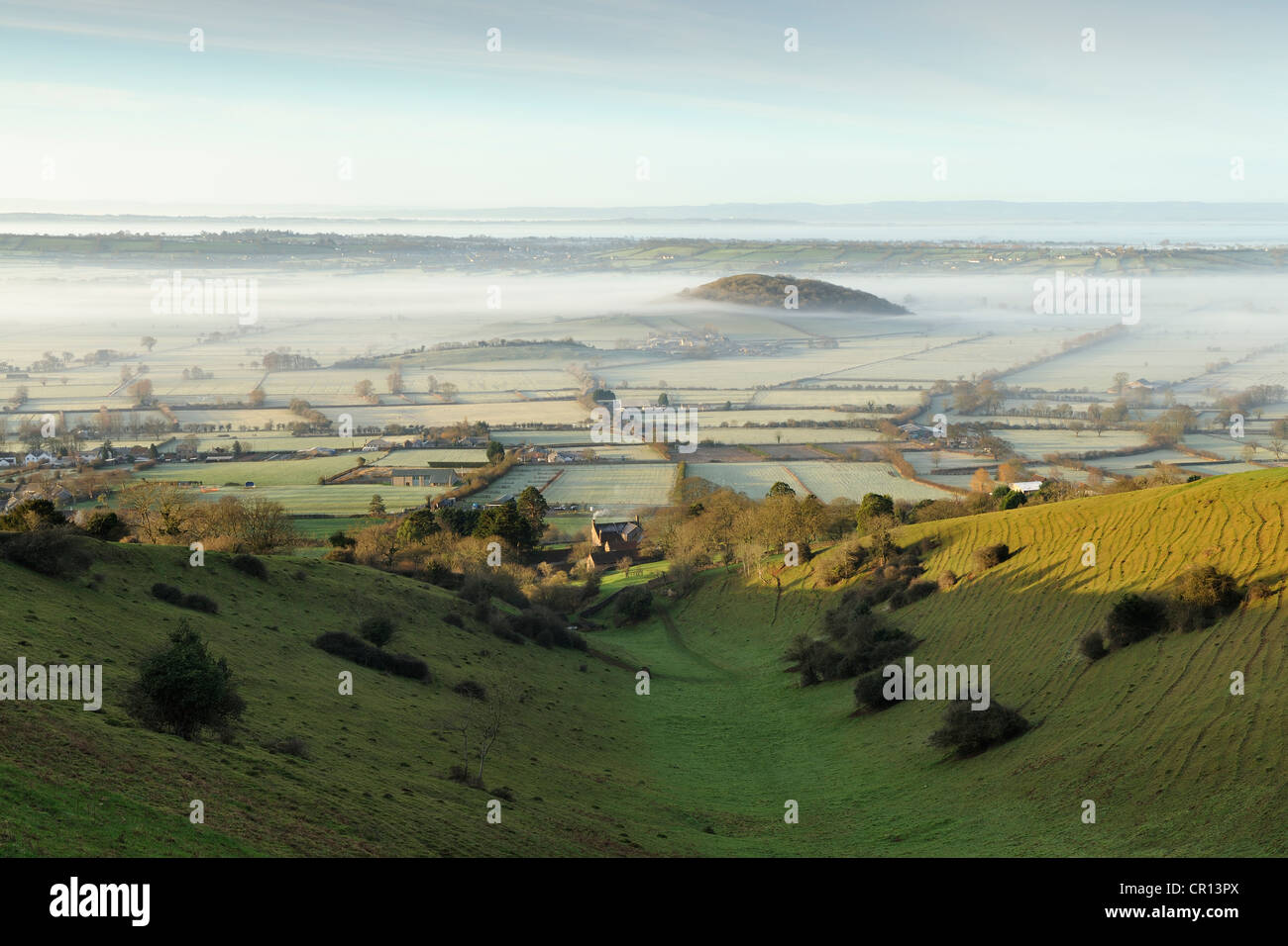 View of mist covering the Somerset Levels, seen from Batcombe Hollow on the Mendip Hills, Somerset, UK. Stock Photo