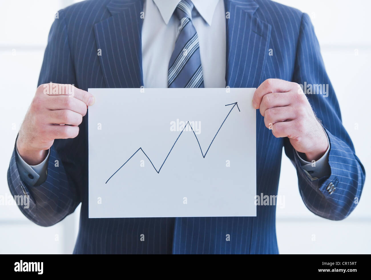 Man wearing suit holding chart Stock Photo