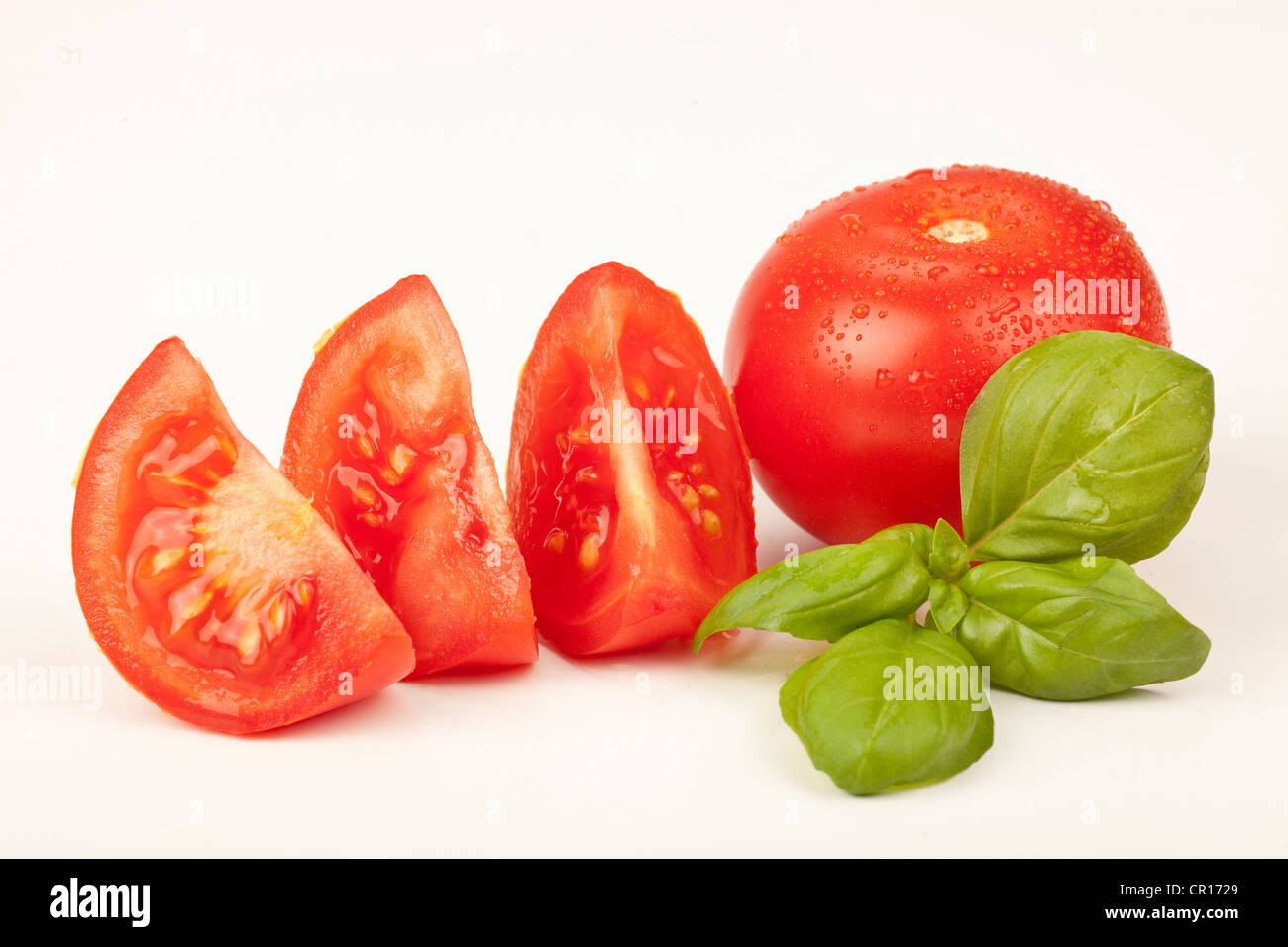 Tomatoes with basil Stock Photo - Alamy