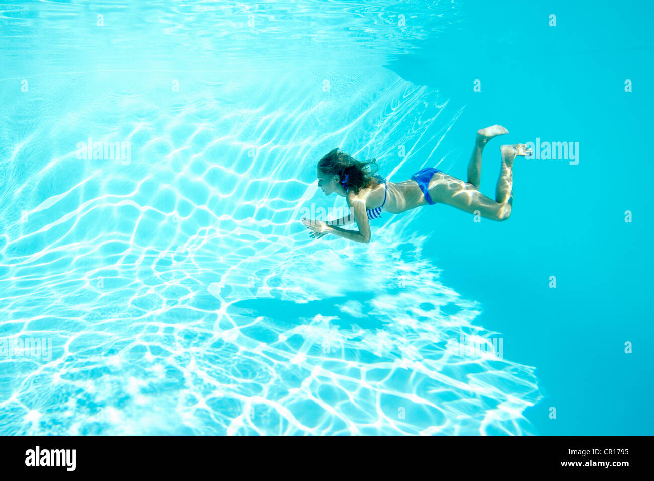 Woman in bikini swimming in pool Stock Photo Alamy