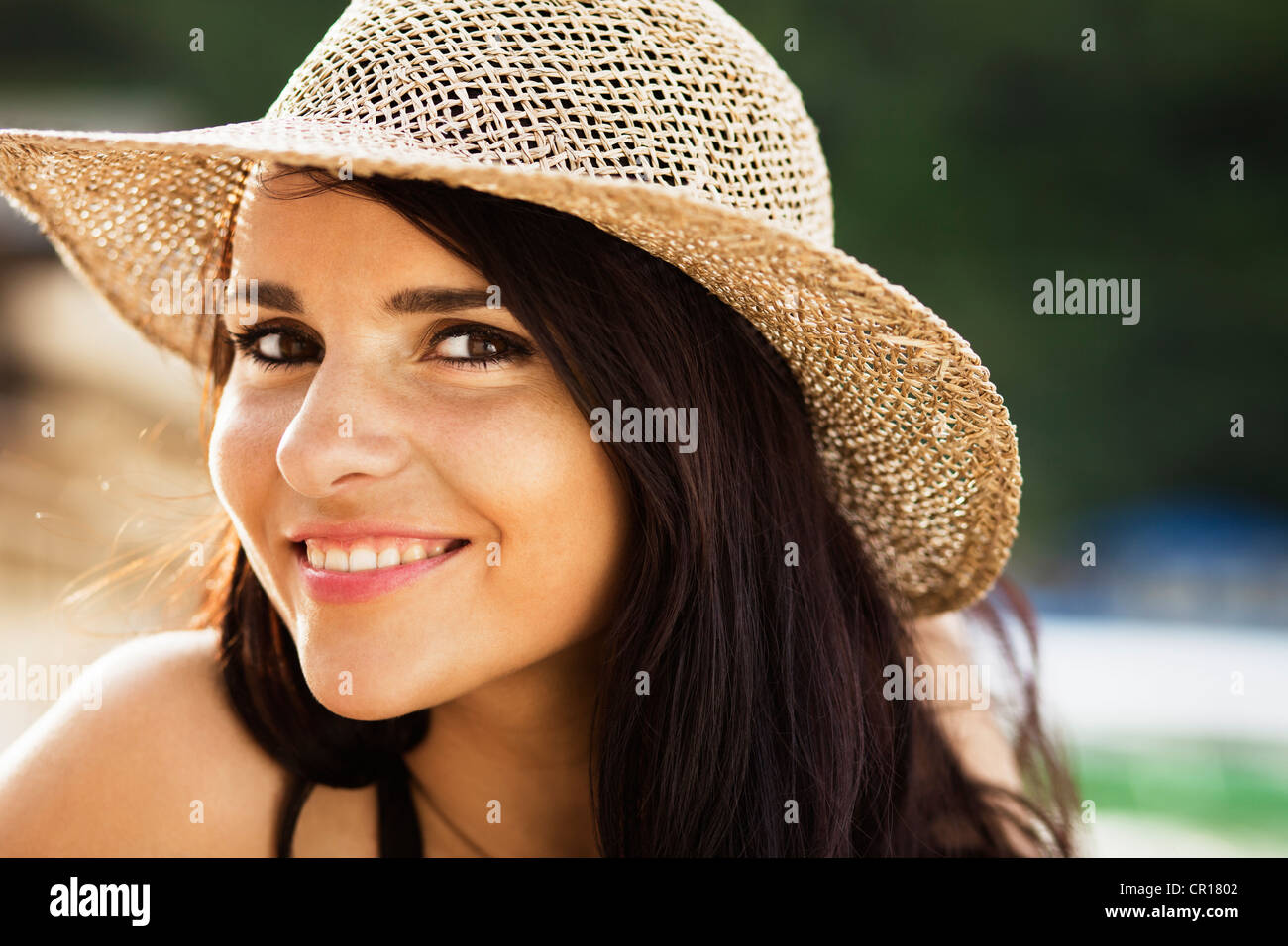 Smiling woman wearing sunhat Stock Photo