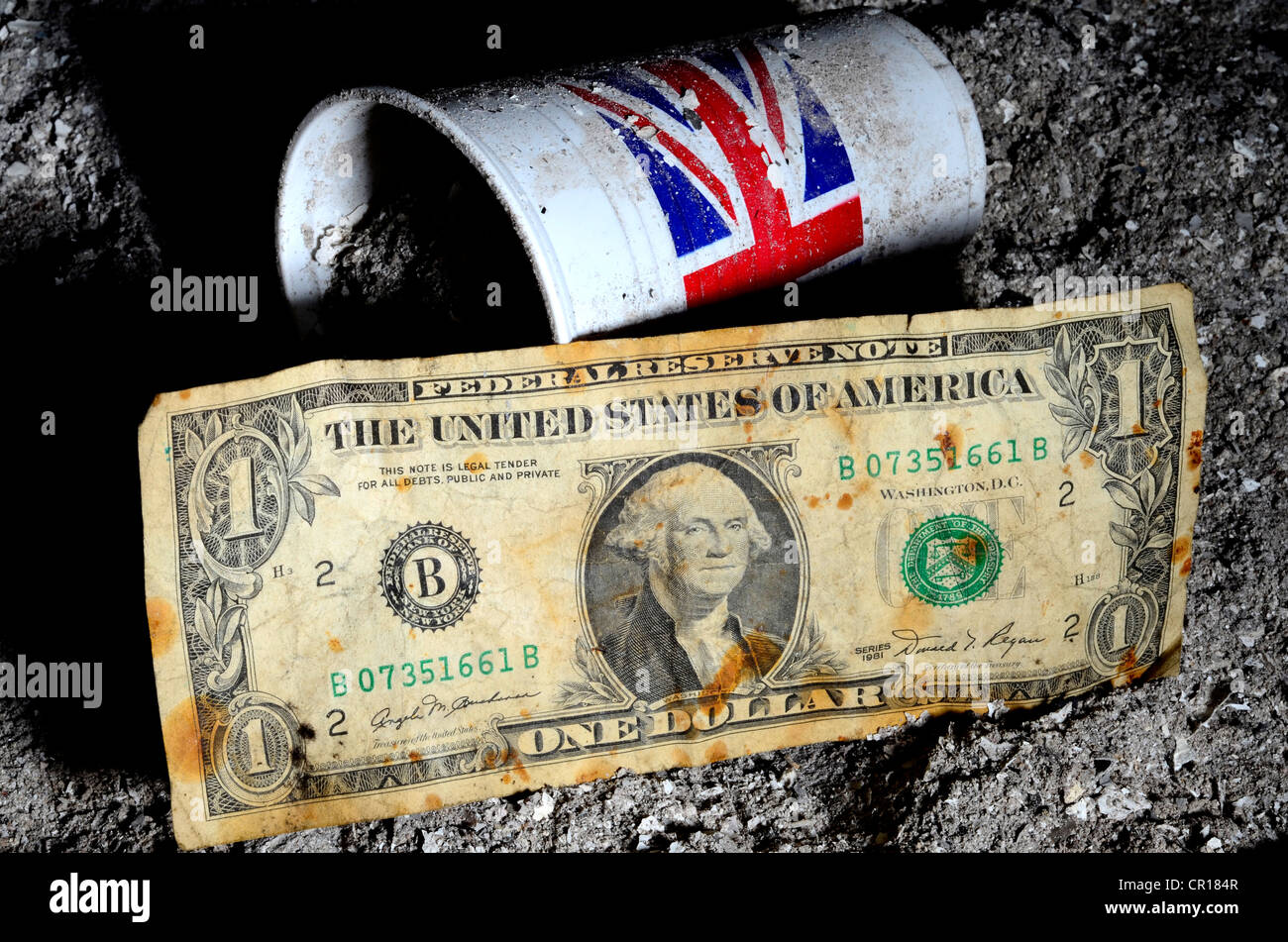 Old dollar bill in pile of ashes with plastic cup with union jack logo