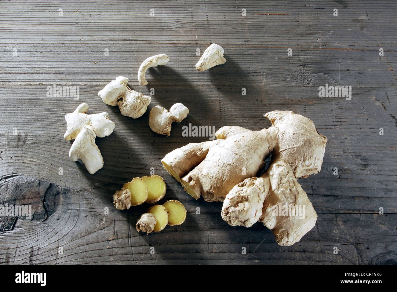 Ginger (Zingiber officinale) rhizome on a rustic wooden surface Stock Photo