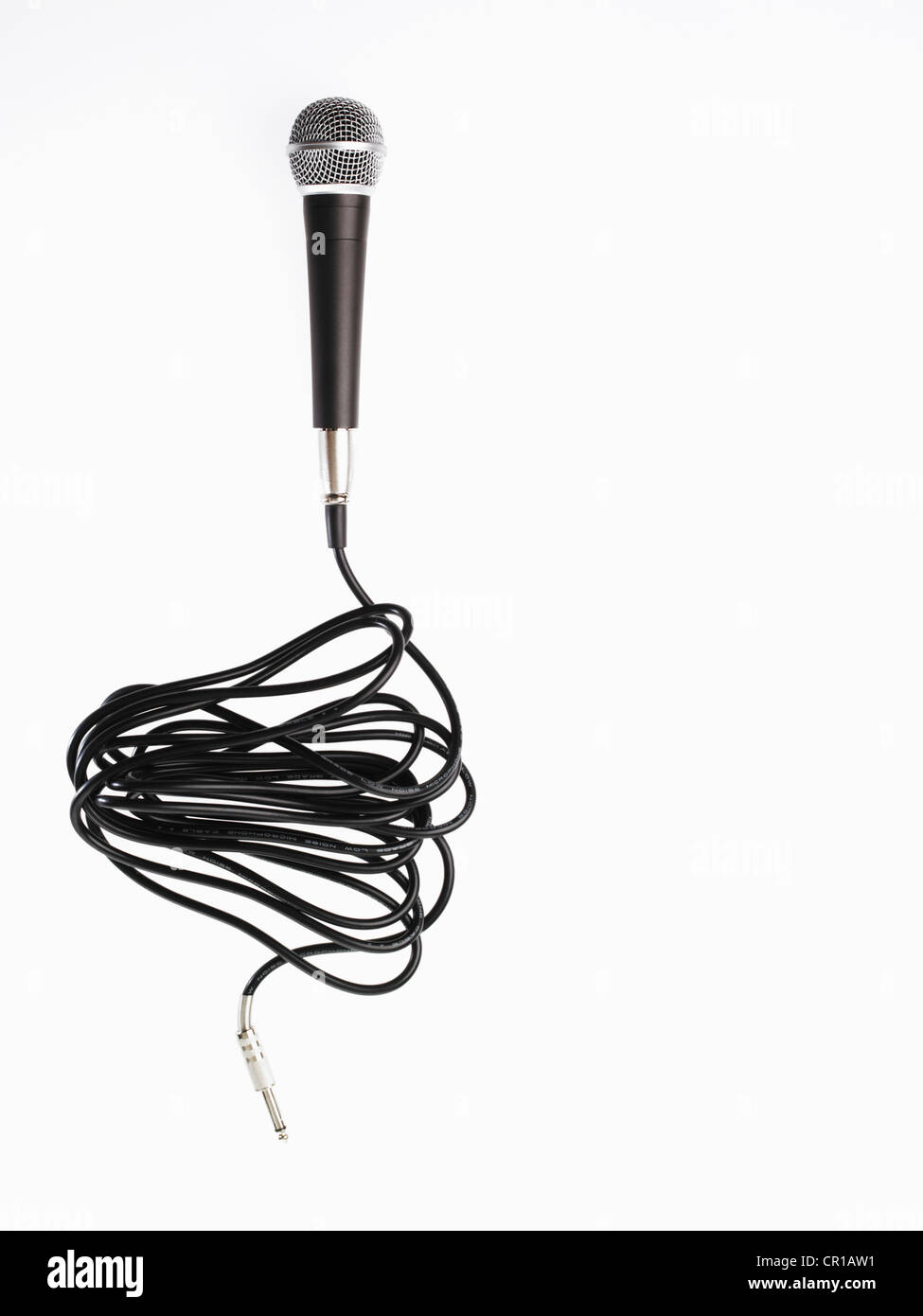 Studio shot of microphone and microphone cable on white background