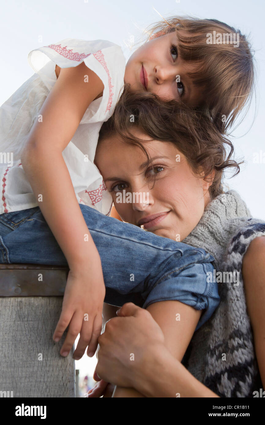 Mother and daughter hugging outdoors Stock Photo