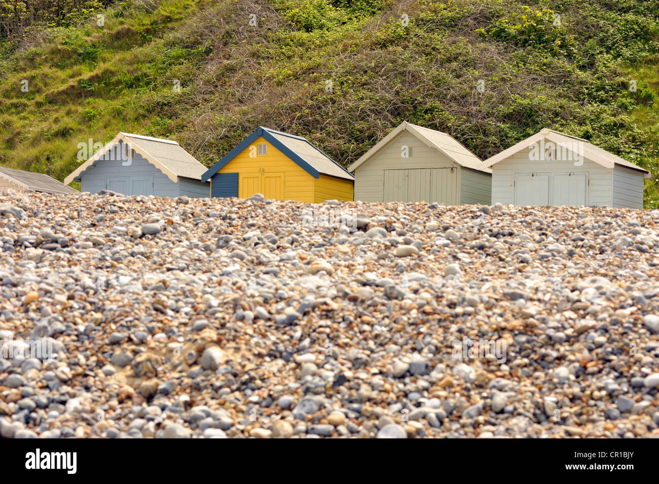 Traditional seaside beach huts along Cromer's East beach in North Norfolk Stock Photo