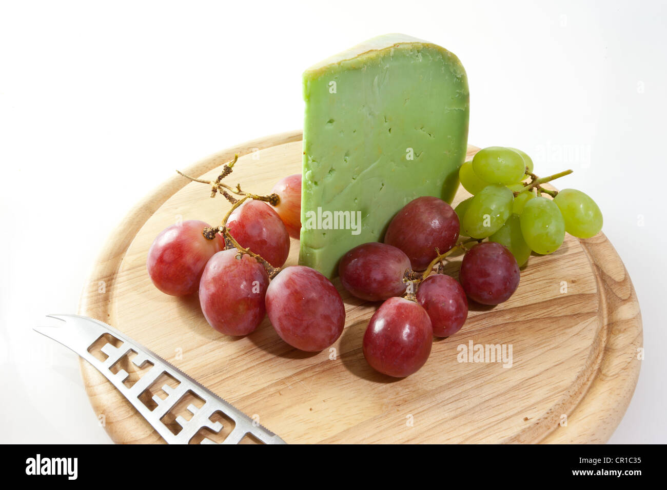 Spicy Japanese wasabi cheese on a board with grapes and bread Stock