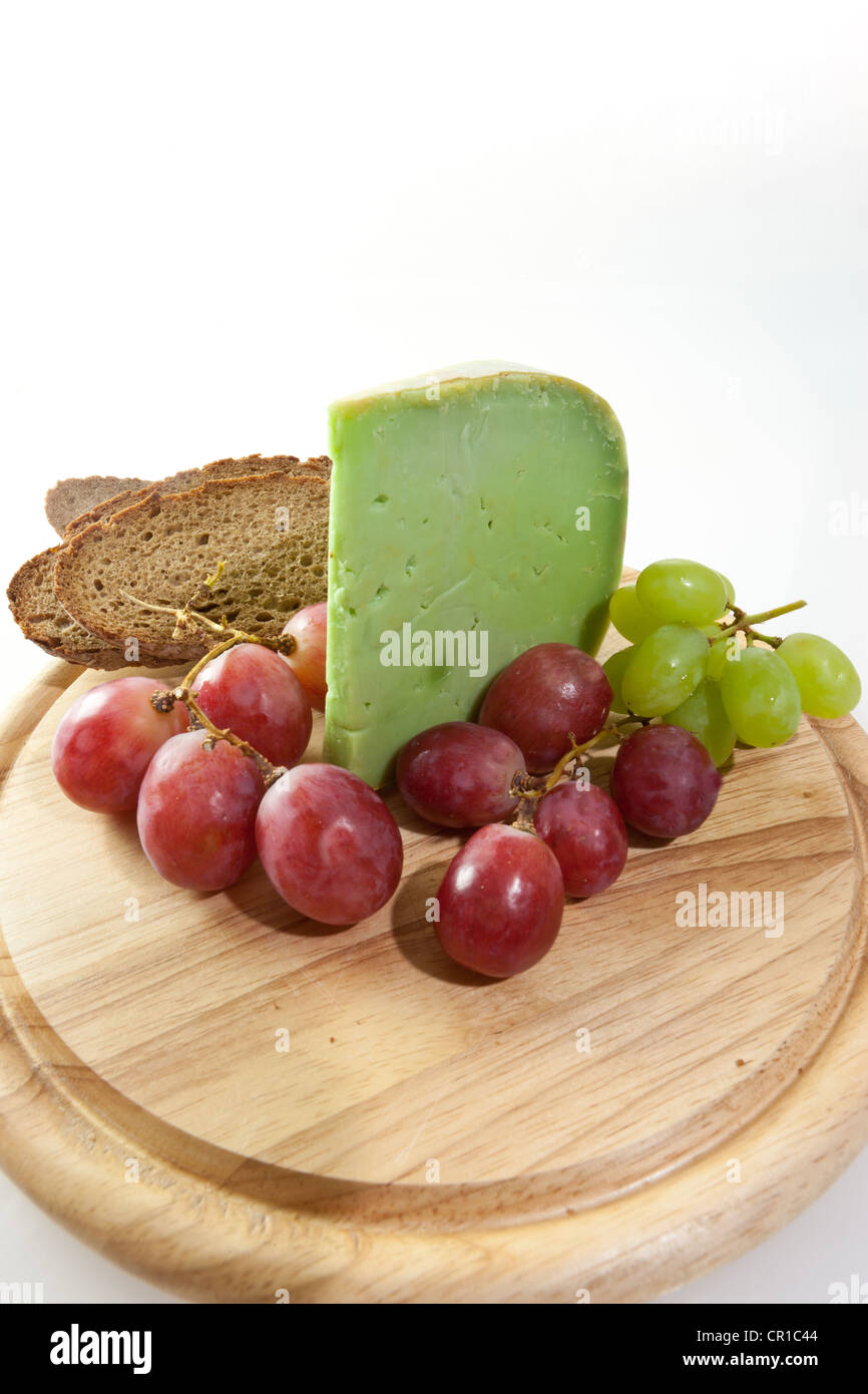 Spicy Japanese wasabi cheese on a board with grapes and bread Stock