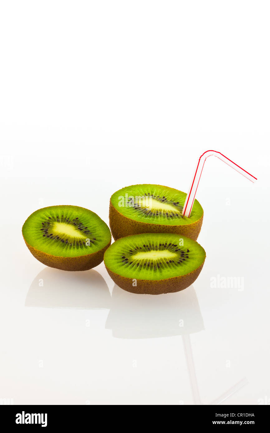Kiwi fruit with a drinking straw as a soft drink Stock Photo