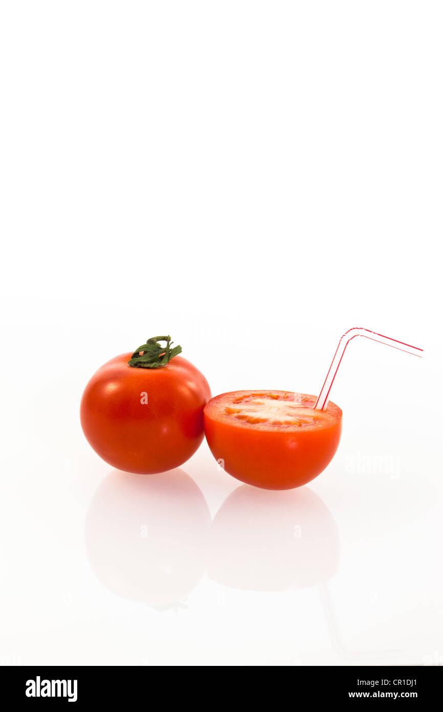 Tomatoes, tomato with a drinking straw as a soft drink Stock Photo