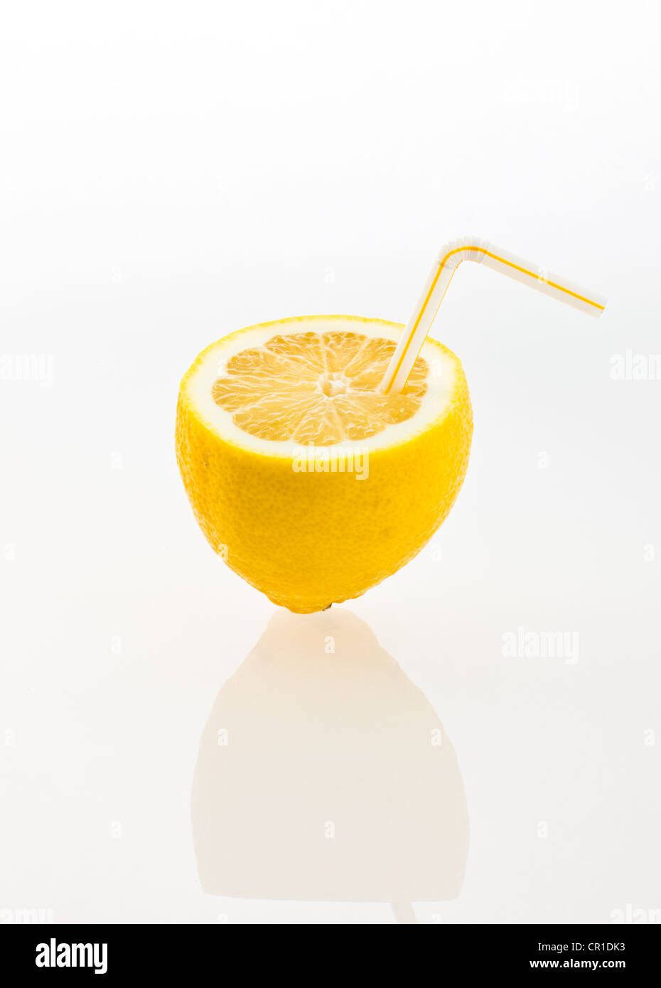 Lemon with a drinking straw as a soft drink Stock Photo