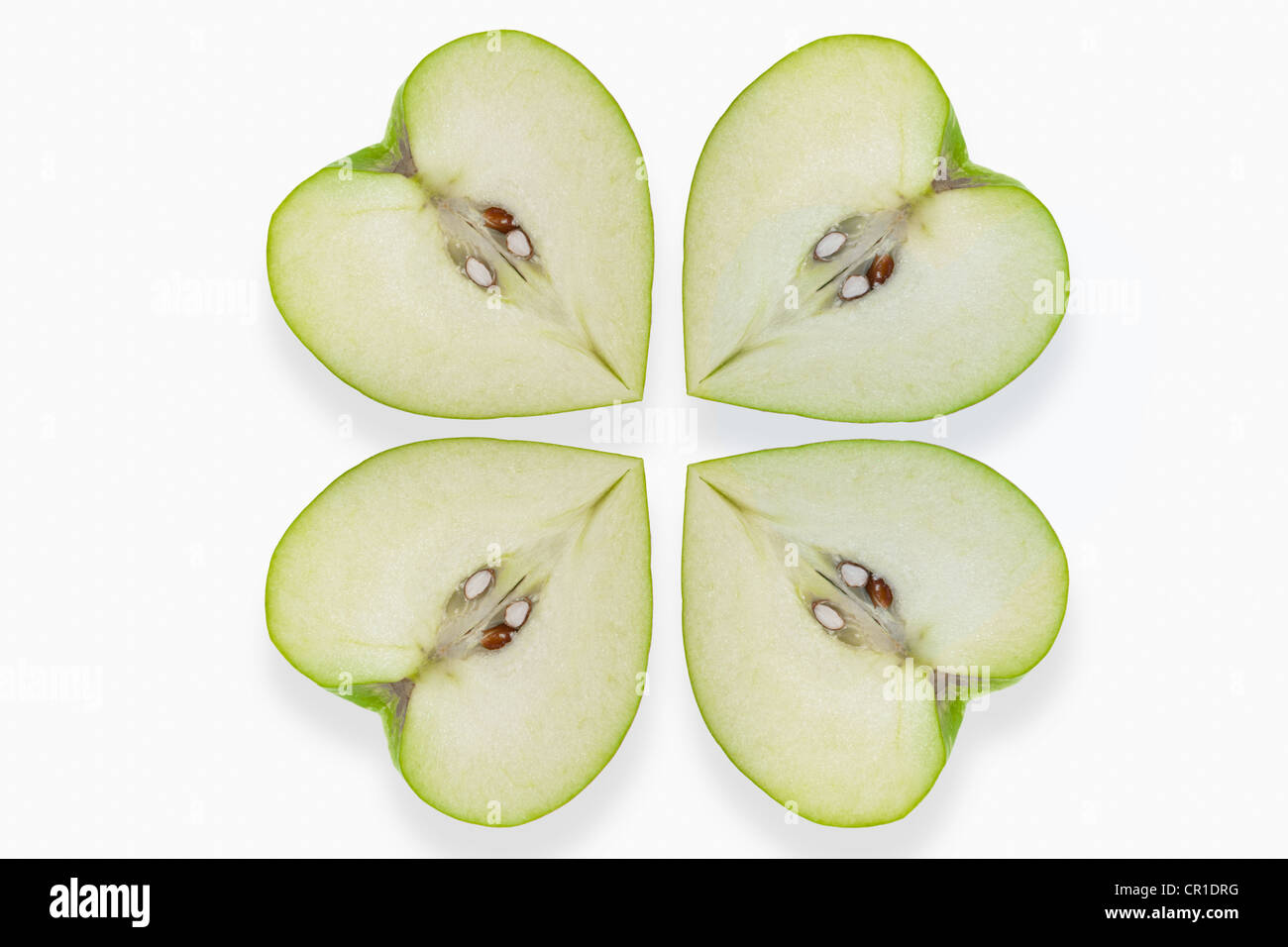 Heart-shaped apples placed like a clover leaf Stock Photo