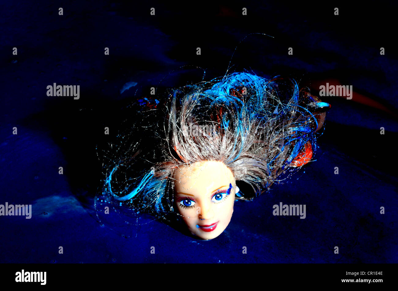 dolls head with blue and red paint Stock Photo