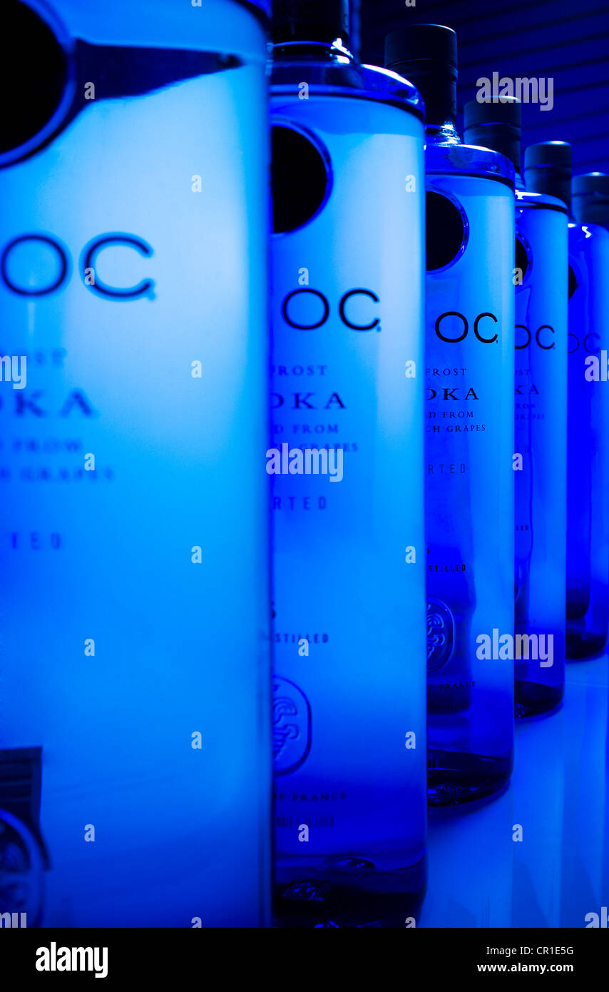 Ciroc Vodka bottles line up in perspective with a blue background. Stock Photo