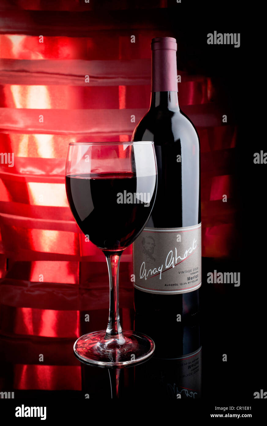 A bottle of Gray Ghost Merlot wine with glass and colorful background Stock Photo