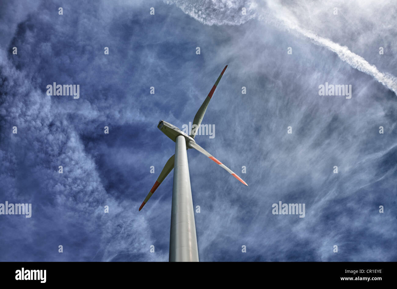 Wind turbine against a blue sky with clouds Stock Photo - Alamy